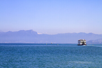 Ferry on Lake Garda with mountain views.