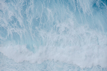 Fototapeta premium Huge crushing waves seen from above creating amazing textures. 