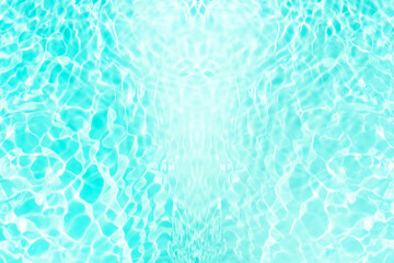 Blue water with ripples on the surface. Defocus blurred transparent blue colored clear calm water surface texture with splashes and bubbles. Water waves with shining pattern texture background.