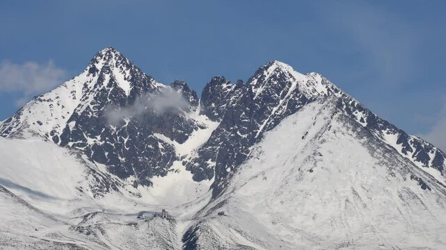 Close up zoom of Lomnicky stit peak in the High Tatras seen from Velka Lomnica in Slovakia