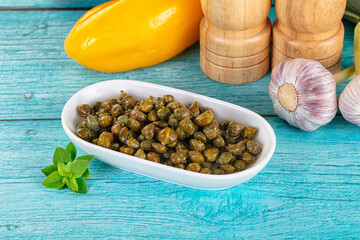 Pickled canned capers in the bowl