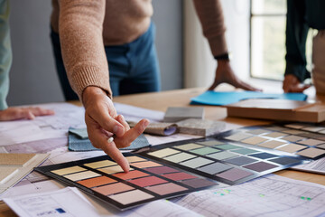 Close up of architect's hand pointing color palette during meeting