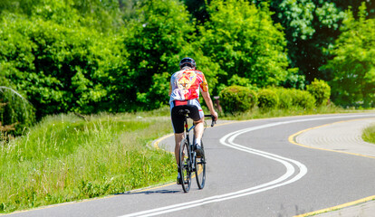 Fototapeta premium Cyclist ride on the bike path in the city Park 