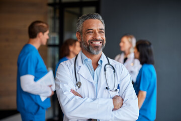 Smiling middle aged indian doctor thinking and looking away © Rido
