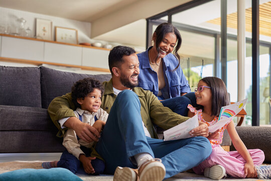 Daughter showing drawings to her indian family at home