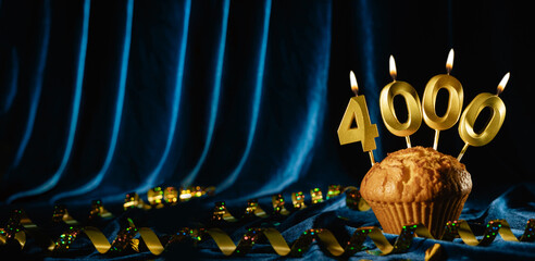 4000 followers card. for social networks and blogs. Festive cupcake with candles number four thousand on blue velvet background. followers card. 4000 online community fans and subscriber.