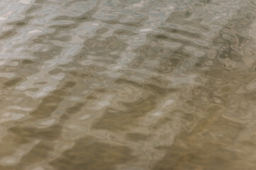 Background, texture of water from a river, sea, ocean with ripples on the surface.
