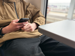 Teenager Using Smartphone on Train