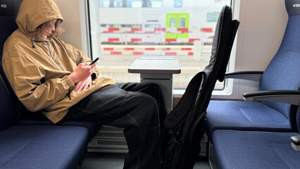 Teenager Using Smartphone on Train