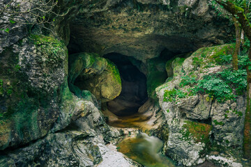 Mountain gorge with caves and little river from the portuguese touristic site of Olhos de Agua - Alviela - Alcanena