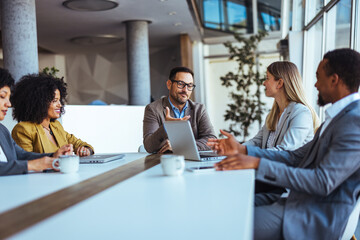 Diverse Business Team Discussing Ideas During a Meeting in a Modern Office
