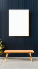 Minimalist interior with light wood bench and blank framed artwork against a dark wall
