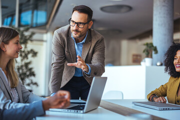Team Leader Giving a Presentation During a Business Meeting in a Modern Office