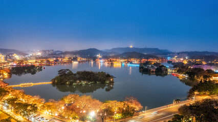 Serene Nightscape Overlooking a Tranquil Lake in a Vibrant City