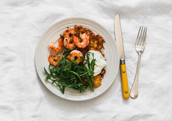 Potato latkes, shrimp, arugula - delicious breakfast, brunch, snack, tapas on a light background, top view