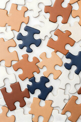 Scattered puzzle pieces in earth tones and navy