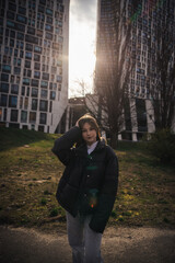 Fototapeta premium Stylish young woman in a black jacket on a city street on a cool day