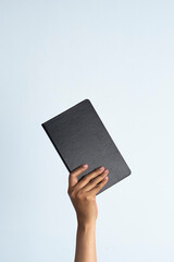 The hands of people hold books. woman's hand holding notebook on white isolated background.