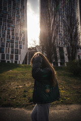 Stylish young woman in a black jacket on a city street on a cool day