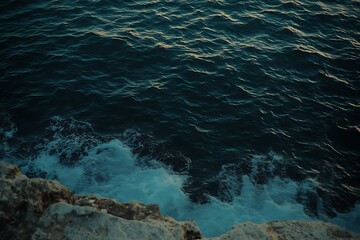 Dark Ocean Waves Crashing on Rocky Coastline