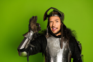 Medieval Knight in Steel Armor Poses on Bright Green Background With Modern Playful Expression