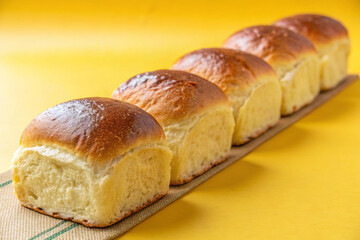 Bread neatly arranged on a yellow background.