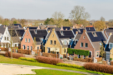 Barendrecht, The Netherlands, March 6, 2025: village-like, traditional brick houses with solar...