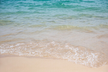 Landscape image of white beach and blue sea