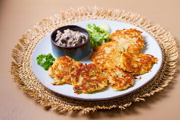 Potato Cakes with creamy mushrooms. Vegetable fritters, latkes, hash browns. Vegetable pancakes