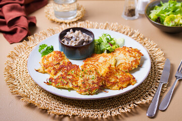 Potato Cakes with creamy mushrooms. Vegetable fritters, latkes, hash browns. Vegetable pancakes