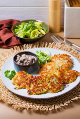 Potato Cakes with creamy mushrooms. Vegetable fritters, latkes, hash browns. Vegetable pancakes