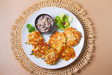 Potato Cakes with creamy mushrooms. Vegetable fritters, latkes, hash browns. Vegetable pancakes. High angle view