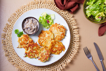 Potato Cakes with creamy mushrooms. Vegetable fritters, latkes, hash browns. Vegetable pancakes. High angle view
