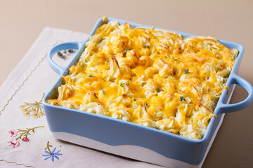 Shepherd's Pie or Cottage Pie in baking dish on brown background. Traditional Irish and British dish