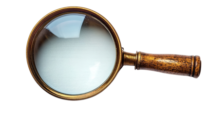 Magnifying Glass: An antique brass magnifying glass isolated, perfect for concepts of investigation, searching and discovery. 