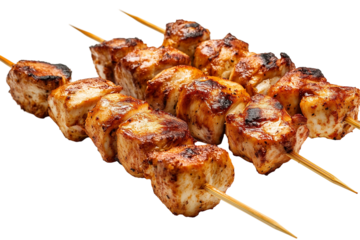 Grilled shish kebabs on skewers over an open flame