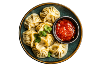 Traditional dumpling momos food from Nepal served with tomato chutney in plate isolated.
 with sauce stuffed chicken, meat, seafood or vegetables.backrounremove