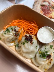 Close-Up of Juicy Steamed Dumplings with Fresh Filling on Plate in Asian Cuisine Setting