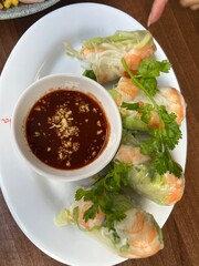 Fresh Vietnamese Spring Rolls with Shrimp and Peanut Dipping Sauce on White Plate