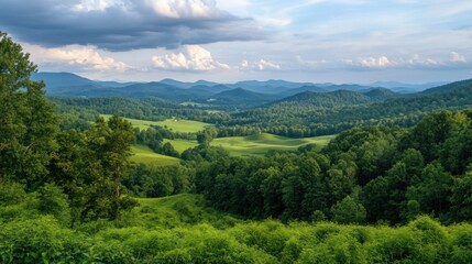 Fototapeta premium A panoramic view of a lush green mountain landscape under clouds