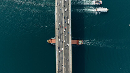 Tanker ship passing under the FSM Bridge with a heavy car traffic on the bridge.Aerial view of The...