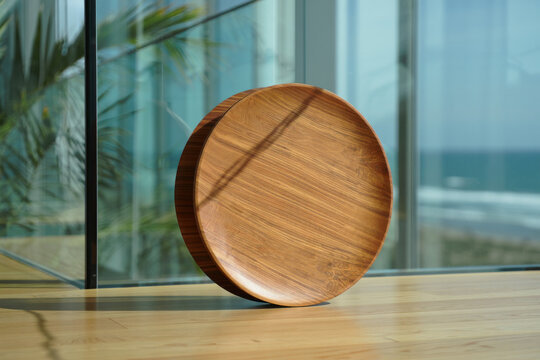 Elegant Round Wooden Tray in Sunlit Modern Interior with Ocean View