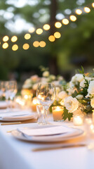 Table with a lot of glasses and utensils, including forks, knives, and spoons