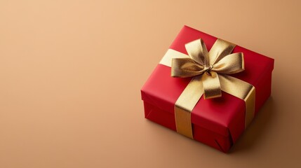 Fototapeta premium Red Gift Box with Gold Ribbon on Beige Background