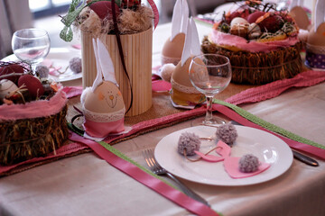 Easter pink handmade bunnies decorate the holiday table, Easter table setting 