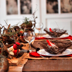 Easter table setting with red décor and branches