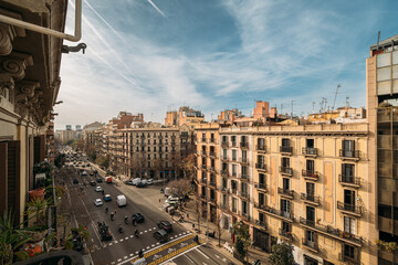 Bustling city street with historic facades and modern life in Barcelona, Spain.