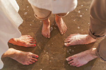 Top view. Legs of family father mother and child. Summer sea, sand