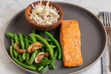 baked salmon with green beans , mushrooms and cole slaw