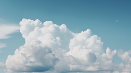 Fluffy white clouds in a clear blue sky.